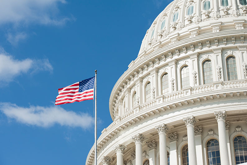 American flag outside government building.