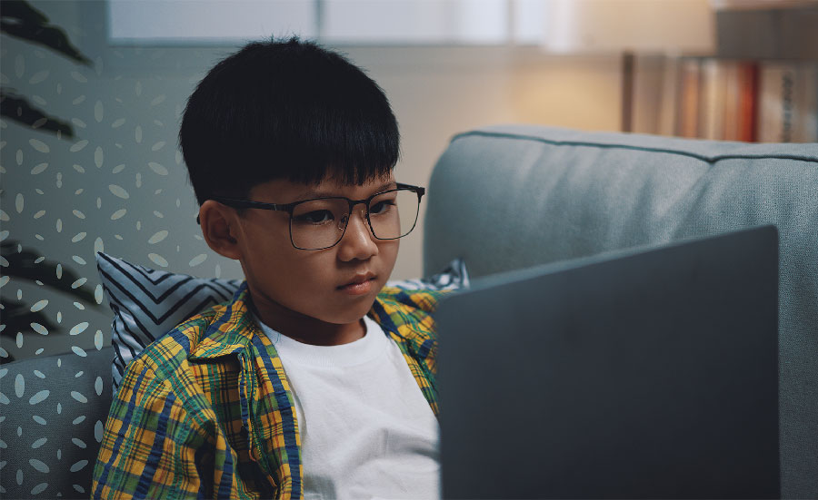 Male student on laptop device.